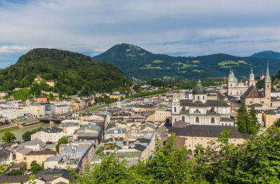 High angle view of townscape and mountains against sky