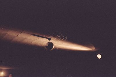 Low angle view of illuminated lighting equipment hanging on ceiling