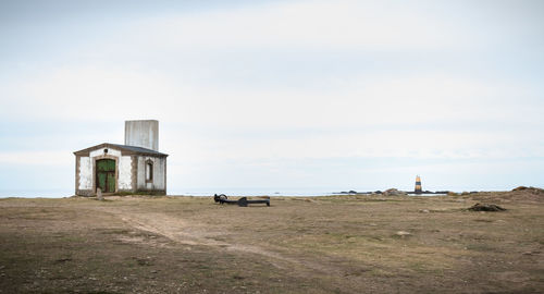 Abandoned built structure on field against sky