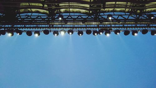 Low angle view of illuminated built structure against blue sky