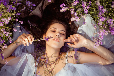 A beautiful young girl against the sunset and a beautiful sky in a lavender field. 