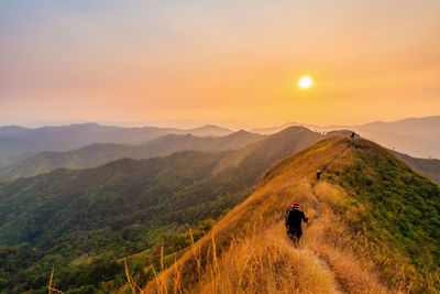 Traveler man hiking enjoying in the mountains with backpack at khao chang puak mountain thailand.