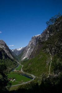 Scenic view of mountains against clear blue sky