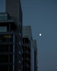 Low angle view of modern buildings against sky at dusk