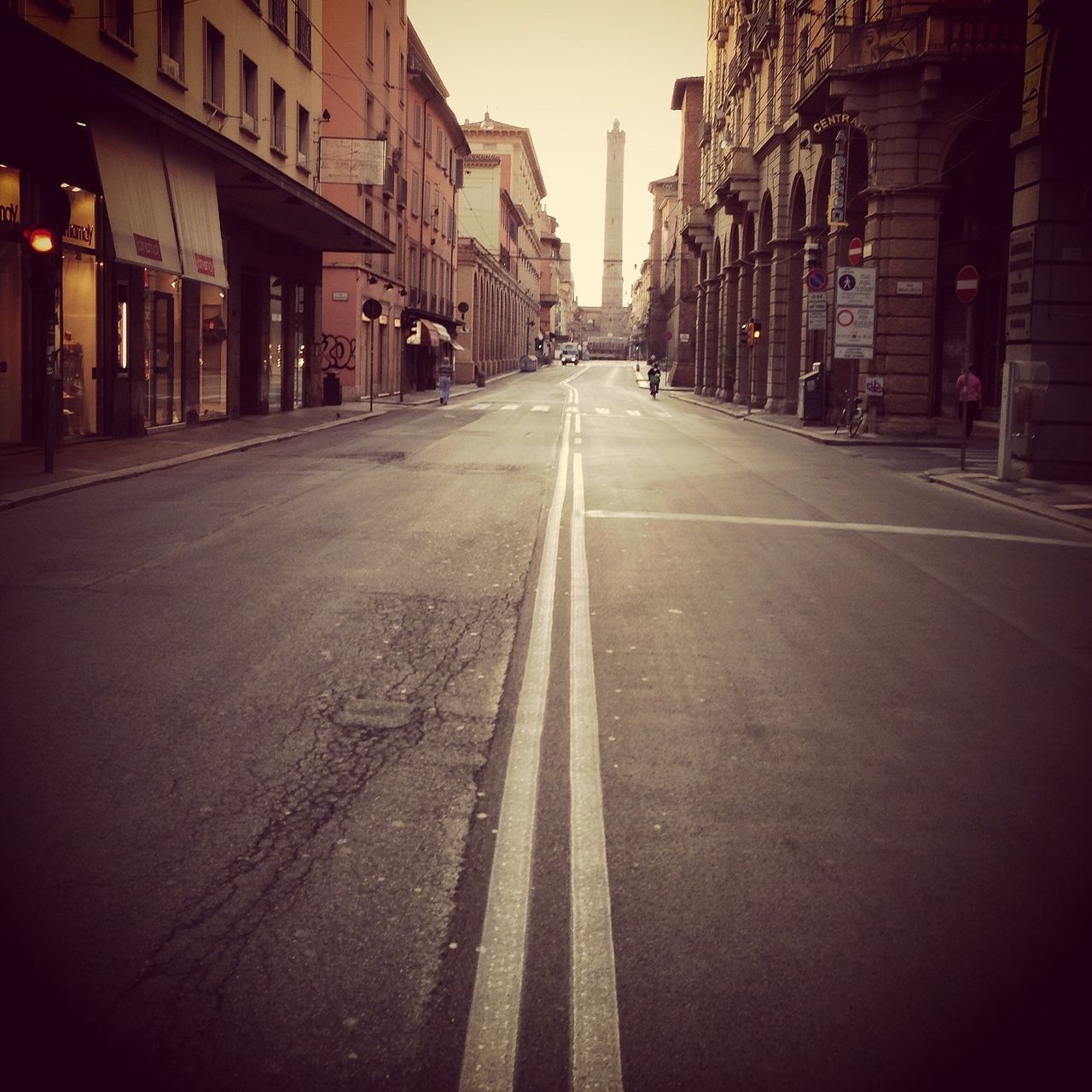 the way forward, building exterior, architecture, diminishing perspective, built structure, vanishing point, transportation, street, city, road, surface level, road marking, building, empty, asphalt, long, street light, outdoors, cobblestone, narrow