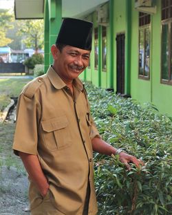 Portrait of smiling man standing outdoors