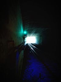 Illuminated tunnel at night