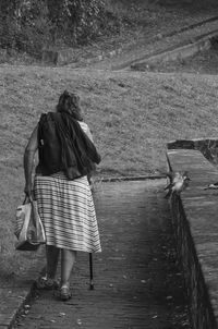 Rear view of a woman walking on pathway