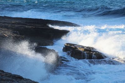 Waves splashing on rocks at shore