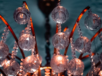 Close-up of lighting equipment hanging on glass