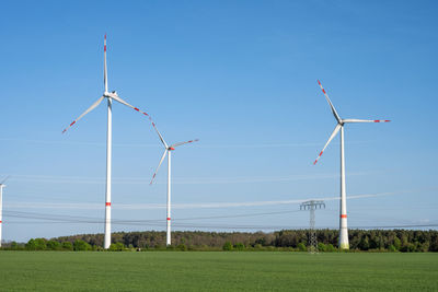 Wind turbines with power lines in the back seen in germany