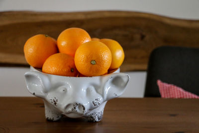 Close-up of orange fruits in bowl on table