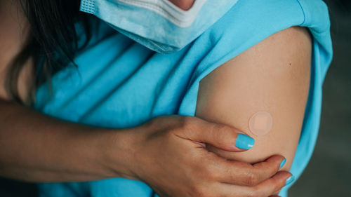 Midsection of woman with blue eyes