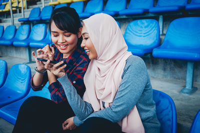 Woman sitting on mobile phone