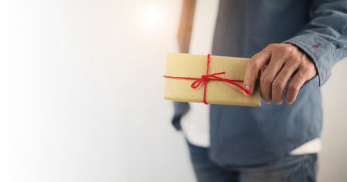 Close-up of hand holding red box