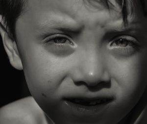 Close-up portrait of cute boy crying