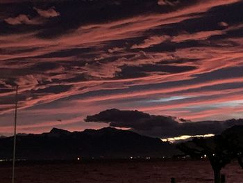 Scenic view of silhouette mountains against sky during sunset