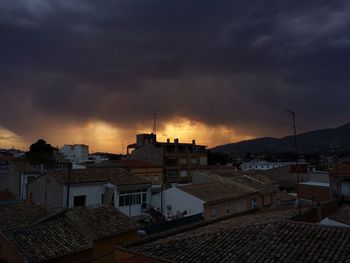 Cityscape against cloudy sky