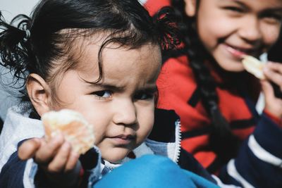 Portrait of smiling girls eating