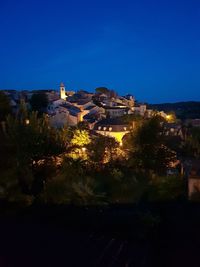 Buildings against blue sky at night