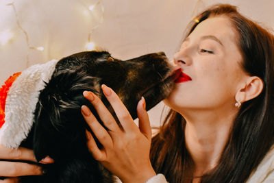 Close-up of young woman with dog