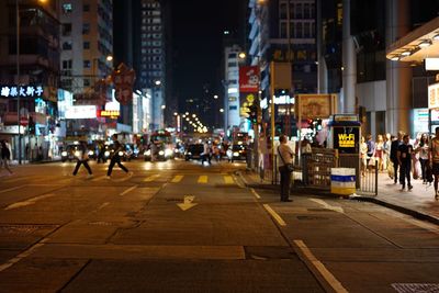 People on street in city at night