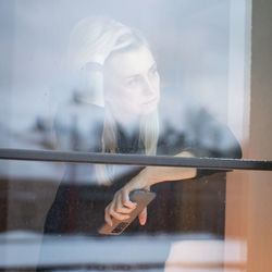 Low angle view of woman using mobile phone