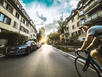 Man riding bicycle on road in city