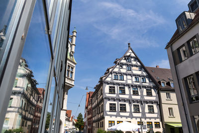 Low angle view of buildings in town against sky