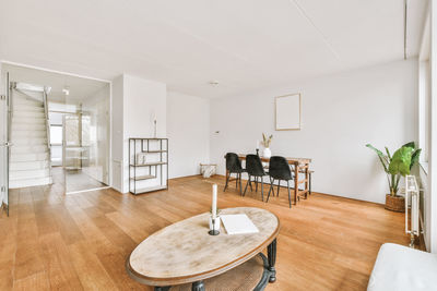 Rear view of woman sitting on floor at home