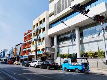 View of city street and buildings against sky