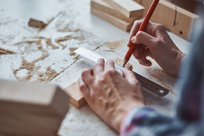 Midsection of carpenter working in workshop