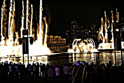 Fountain in city at night
