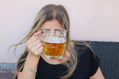 Mature woman looking through beer glass