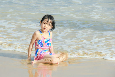 Girl playing in water at beach