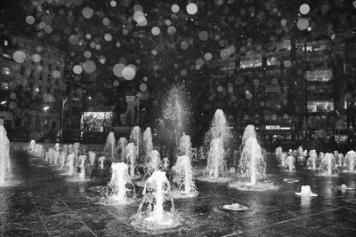 Fountain in city at night