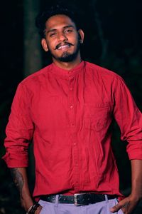 Portrait of young man standing outdoors ,  smiling on face, looks charming