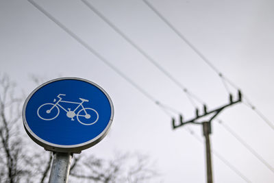 Low angle view of road sign against clear sky