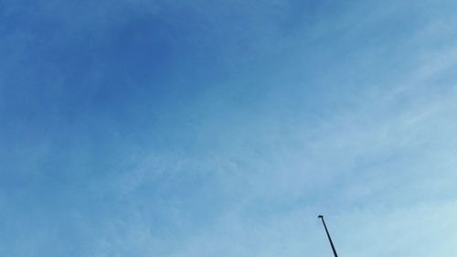 High section of street light against blue sky