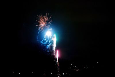 Low angle view of firework display at night