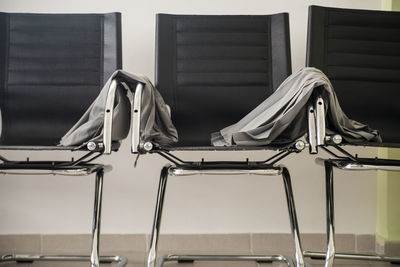 Close-up of empty chairs in barber shop