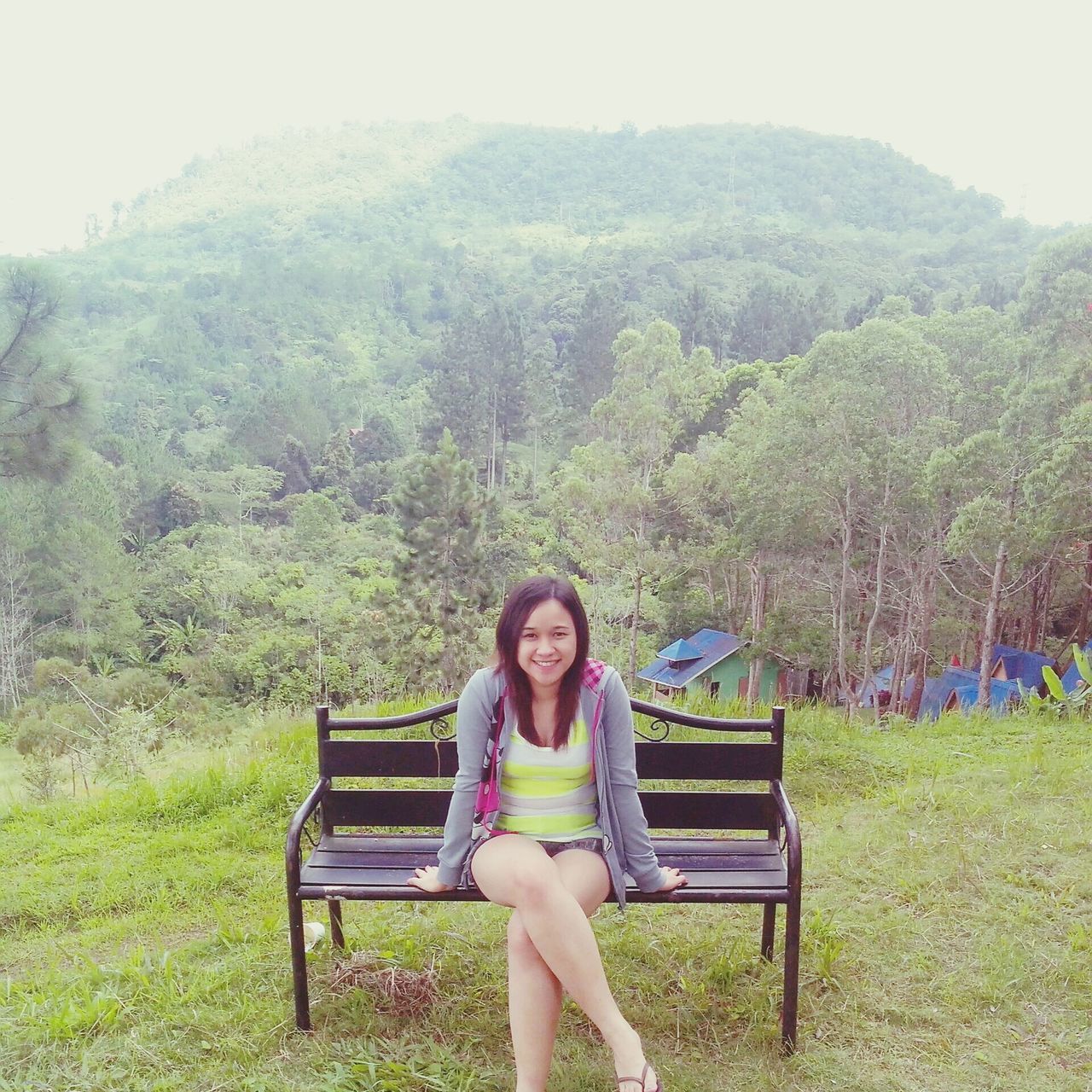 lifestyles, leisure activity, sitting, relaxation, young adult, tree, casual clothing, person, young women, bench, full length, grass, tranquility, vacations, chair, nature, mountain, tranquil scene