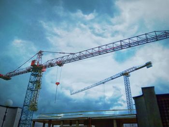 Low angle view of crane against sky