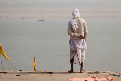 Rear view of man standing on beach