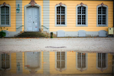 Reflection of building on wet glass window