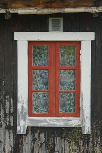 Closed window of old wooden building