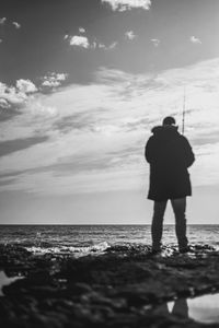 Rear view of man standing on beach