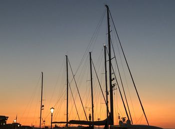 Silhouette sailboats on sea against sky during sunset