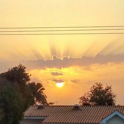 Low angle view of houses against sky at sunset