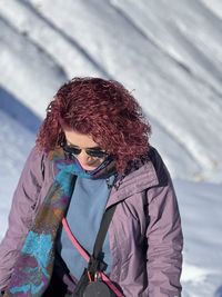 Portrait of young woman wearing sunglasses standing outdoors
